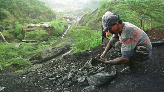 A man collects dirt and stones dug from a tunnel in Muzo, in the heart of Colombia's emerald-mining region (AP Photo/Ricardo Mazalan)