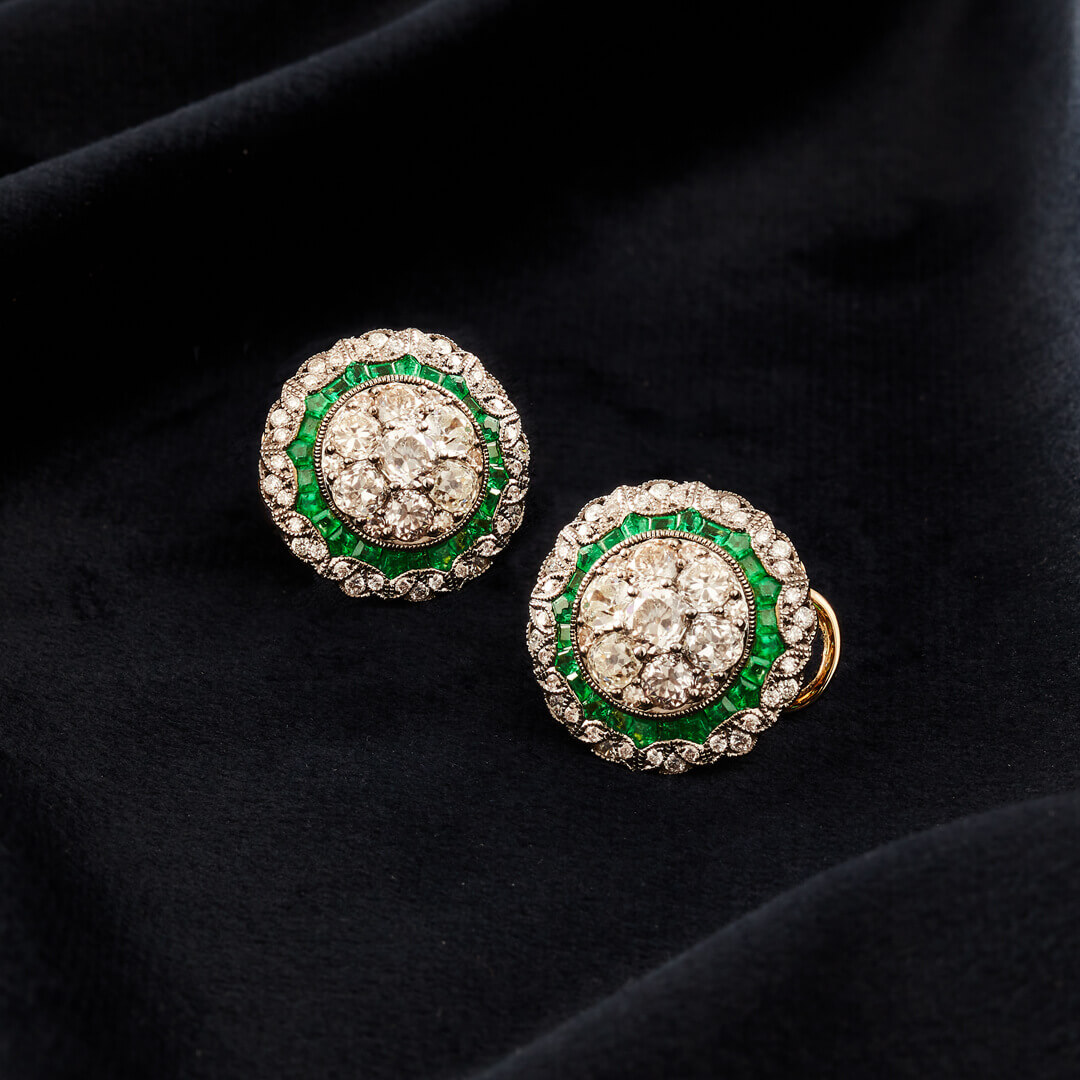 A Pair of Large 18ct White Gold Target Cluster Earrings set with Emeralds and Diamonds