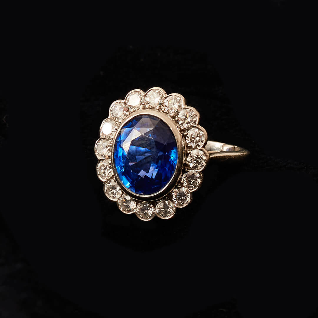 A Platinum, Large Sapphire and Diamond Oval Cluster Ring